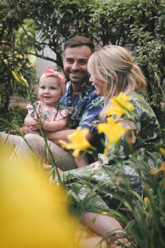 A family sitting together among yellow flowers in a Nairobi garden