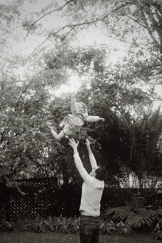 A child flying up into the air during family play